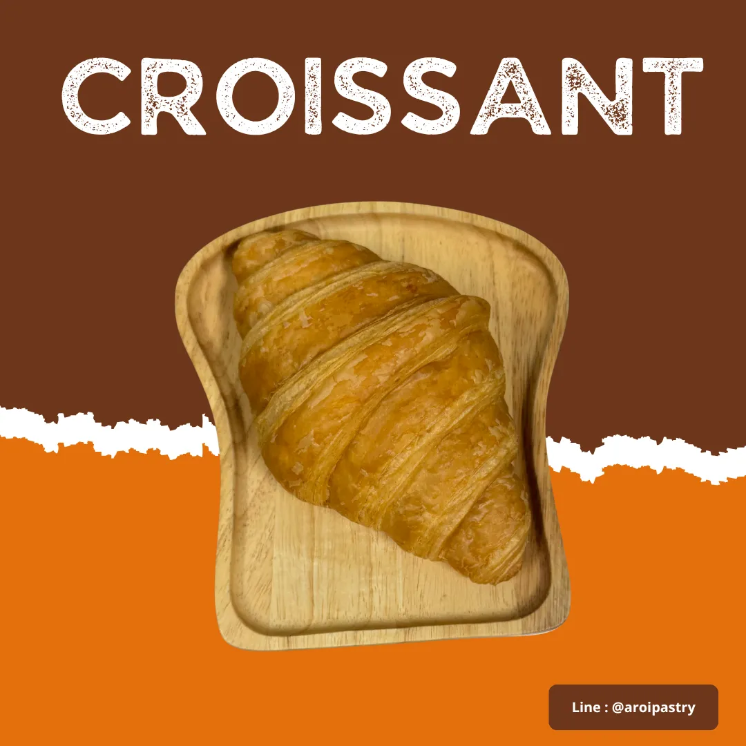 Golden baked croissants displayed on a serving board