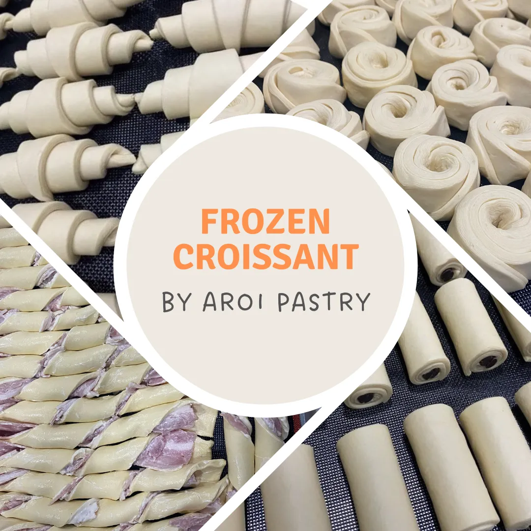 Raw frozen croissants arranged on a tray, ready for baking
